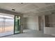 Bright living space featuring an open layout and large sliding glass doors awaiting finishing touches at 24080 W Bowker St, Buckeye, AZ 85326