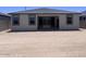 Exterior view of the backyard featuring a dirt yard and a home with a tile roof at 24088 W Bowker St, Buckeye, AZ 85326