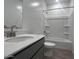 Bright bathroom with walk-in shower, gray vanity, and wood-look tile flooring at 24088 W Bowker St, Buckeye, AZ 85326