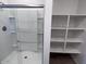 Bathroom featuring a glass-enclosed shower and built-in shelving at 24088 W Bowker St, Buckeye, AZ 85326