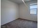 Bedroom features a large window that provides natural light and neutral colored carpeted floors at 24088 W Bowker St, Buckeye, AZ 85326
