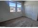Bedroom with carpet, two windows, and a closet at 24088 W Bowker St, Buckeye, AZ 85326
