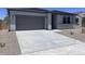 Exterior view of the home with a garage and driveway at 24088 W Bowker St, Buckeye, AZ 85326