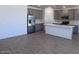 Modern kitchen featuring gray cabinets, stainless steel appliances, and a kitchen island at 24088 W Bowker St, Buckeye, AZ 85326