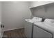 A laundry room features a washer, dryer, and shelving at 24088 W Bowker St, Buckeye, AZ 85326