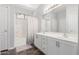 Bright bathroom featuring double sinks, vanity, large mirror, and a shower with a bathtub at 24824 W Pueblo Ave, Buckeye, AZ 85326