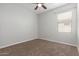 Bedroom featuring a ceiling fan, neutral-colored walls, and carpet, providing a comfortable atmosphere at 24824 W Pueblo Ave, Buckeye, AZ 85326