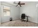 Bedroom with a ceiling fan, carpeted floor, a desk with a black chair and a window at 24824 W Pueblo Ave, Buckeye, AZ 85326
