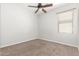 Bedroom featuring a ceiling fan, neutral-colored walls, and carpet, providing a comfortable atmosphere at 24824 W Pueblo Ave, Buckeye, AZ 85326
