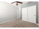 Bedroom with a ceiling fan, neutral-colored walls, carpet, and closet with sliding doors at 24824 W Pueblo Ave, Buckeye, AZ 85326