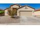Inviting single-Gathering home featuring desert landscaping and a two-car garage on a sunny day at 24824 W Pueblo Ave, Buckeye, AZ 85326
