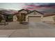 Charming single-story home featuring a well-manicured front yard, a spacious driveway, and a welcoming two-car garage at 24824 W Pueblo Ave, Buckeye, AZ 85326