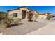 Well-maintained home featuring desert landscaping, and a covered porch at 24824 W Pueblo Ave, Buckeye, AZ 85326