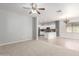 Living room with carpet and tile flooring and views into the kitchen at 24824 W Pueblo Ave, Buckeye, AZ 85326