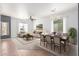 Open-concept living and dining room with neutral tones and lots of natural light at 24824 W Pueblo Ave, Buckeye, AZ 85326