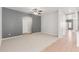 Open-concept living room featuring neutral carpet and easy access to other rooms at 24824 W Pueblo Ave, Buckeye, AZ 85326