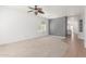Well-lit living room with neutral carpet and views of the backyard at 24824 W Pueblo Ave, Buckeye, AZ 85326