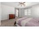 Bedroom featuring a neutral color scheme, ceiling fan, and an ensuite bathroom at 24824 W Pueblo Ave, Buckeye, AZ 85326