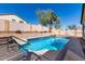 Beautiful backyard with a refreshing pool, landscaped surroundings, and a soothing waterfall feature for ultimate relaxation at 24824 W Pueblo Ave, Buckeye, AZ 85326