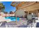 Inviting backyard oasis with a refreshing pool and a charming shaded patio area, perfect for outdoor relaxation and entertaining at 24824 W Pueblo Ave, Buckeye, AZ 85326