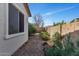 View of the low-maintenance backyard showcasing desert landscaping and a privacy wall at 266 N Piedra Way, Mesa, AZ 85207