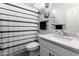 Charming bathroom with stylish decor, including geometric shower curtain at 266 N Piedra Way, Mesa, AZ 85207