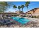 Community pool area featuring chaise lounge chairs and palm trees at 266 N Piedra Way, Mesa, AZ 85207