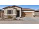 Charming single-Gathering home with a two-car garage, stone accents, and well-kept desert landscaping at 266 N Piedra Way, Mesa, AZ 85207