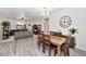 Inviting living room and dining room combination with wood-look floors and plenty of natural light at 266 N Piedra Way, Mesa, AZ 85207