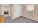 Spare bedroom with sliding closet, neutral carpet, and large window with blinds at 2708 S Santa Rita --, Mesa, AZ 85209