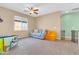 Spacious bonus room with neutral carpet, blue couch, and a play area for  at 2708 S Santa Rita --, Mesa, AZ 85209