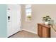 Bright entryway featuring tile flooring, a wooden storage cabinet, and natural light at 2708 S Santa Rita --, Mesa, AZ 85209