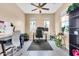 Bright home office with two windows, tile floors, black desk and chair, and a ceiling fan at 2708 S Santa Rita --, Mesa, AZ 85209