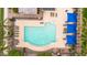 Aerial view of a community pool with lounge chairs and covered seating at 2708 S Santa Rita --, Mesa, AZ 85209