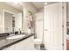 Bathroom featuring a black granite countertop, new vanity, and a separate toilet and shower area at 3252 E Fremont Rd, Phoenix, AZ 85042