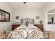 Inviting bedroom with a decorative metal bed frame and well-lit bedside tables at 3252 E Fremont Rd, Phoenix, AZ 85042
