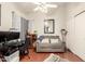 Cozy bedroom showcasing a loveseat, desk, and closet, illuminated by a ceiling fan at 3252 E Fremont Rd, Phoenix, AZ 85042