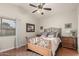 Cozy bedroom with hardwood floors, ceiling fan, and a decorative metal bed frame at 3252 E Fremont Rd, Phoenix, AZ 85042