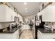 Bright kitchen with stainless appliances, white cabinets, and dark counters provides ample counter space at 3252 E Fremont Rd, Phoenix, AZ 85042