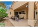 Comfortable outdoor patio features neutral furnishings, a ceiling fan, and a grill for enjoyable outdoor living at 3252 E Fremont Rd, Phoenix, AZ 85042