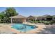 Community pool with lounge chairs, covered seating and mature trees at 3252 E Fremont Rd, Phoenix, AZ 85042