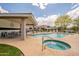 Community pool with a jacuzzi, shady pergola, seating, and ample space for entertaining at 3252 E Fremont Rd, Phoenix, AZ 85042