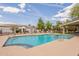 Community pool with well-kept tile, lounge seating, shaded pergola, and well-manicured green spaces at 3252 E Fremont Rd, Phoenix, AZ 85042