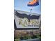 Raven Golf Club sign with stone base and Arizona flag at 3252 E Fremont Rd, Phoenix, AZ 85042
