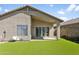 Backyard featuring low-maintenance artificial grass and access to the covered patio at 3407 W Steinbeck Dr, Anthem, AZ 85086