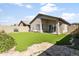 Lush backyard with artificial grass, patio, desert landscaping, and stone pathway at 3407 W Steinbeck Dr, Anthem, AZ 85086