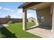 Inviting backyard featuring a covered patio and well-maintained artificial grass at 3407 W Steinbeck Dr, Anthem, AZ 85086