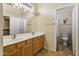 Spacious bathroom features a double sink vanity, linoleum floors, and an adjoined toilet at 3407 W Steinbeck Dr, Anthem, AZ 85086