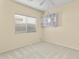 Neutral bedroom showcasing a large window, ceiling fan, and built-in shelving unit at 3407 W Steinbeck Dr, Anthem, AZ 85086