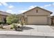 Inviting single-story home with a well-maintained front yard, featuring desert plants, and a two-car garage at 3407 W Steinbeck Dr, Anthem, AZ 85086
